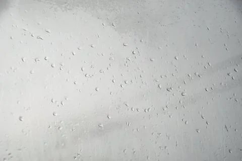 Raindrops on window pane. Blurred background outside the window in the rain. Stock Photos