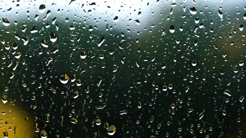Raindrops on Window Pane with Blurred Nature Background Stock Footage 339026784