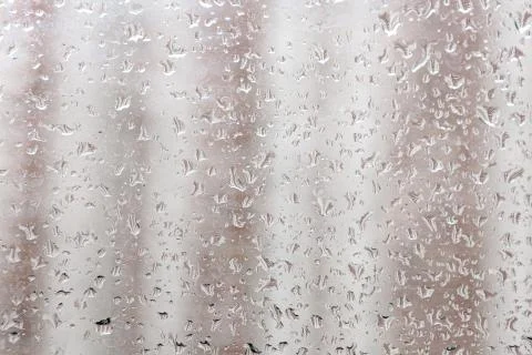 Raindrops on a window pane. Cloudy weather, it is raining. Stock Photos