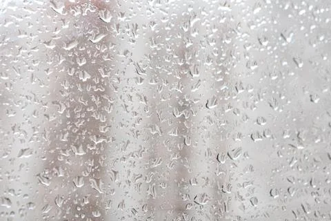 Raindrops on a window pane. Cloudy weather, it is raining. Stock Photos