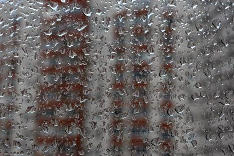 Raindrops on a window pane. Cloudy weather, it is raining. Stock Photos