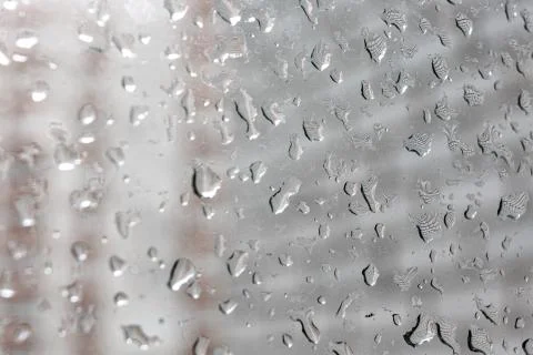 Raindrops on a window pane. Cloudy weather, it is raining. Stock Photos