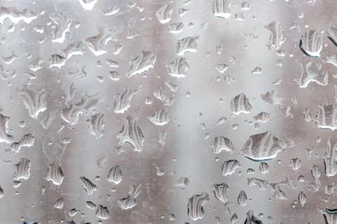 Raindrops on a window pane. Cloudy weather, it is raining. Stock Photos