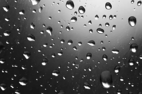 Raindrops on window pane on a cold day of winter Stock Photos