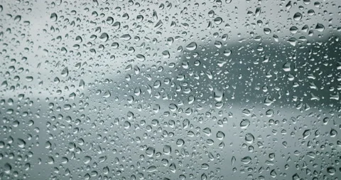 Raindrops on a window pane. Severe sea waves foam outside. Dramatic cloudy Stock Footage 238681139