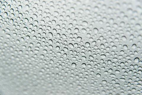 Raindrops on a window a rainy day Stock Photos