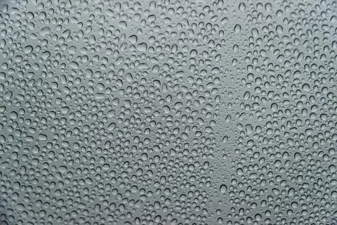 Raindrops on a window a rainy day Stock Photos