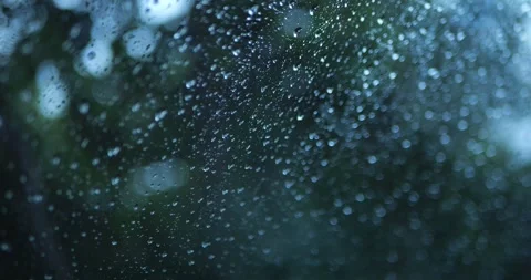 Raindrops On Window With Soft Green Bokeh Background... Stock Footage 332075522