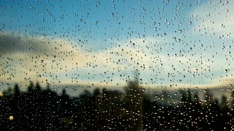 The raindrops on the window. Sunny blue sky with clouds Stock Footage 144642042