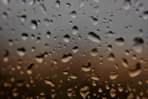 Raindrops on Window with Sunset Colors Stock Photos