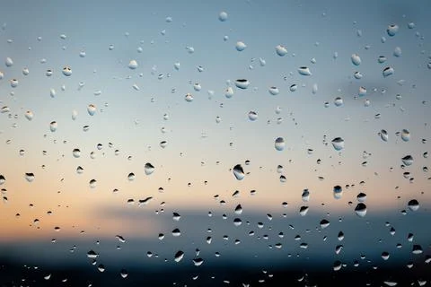 Raindrops on window at sunset Stock Photos