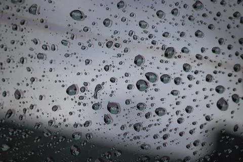 Raindrops on a window surface, close up Stock Photos