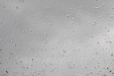 Raindrops on the window - view out the window outwards, rainy weather Stock Photos