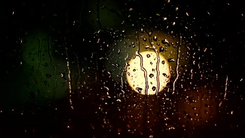Raindrops on Window with Warm Streetlight Glow 스톡 동영상 327107319