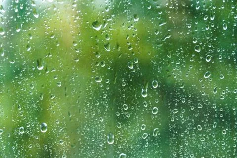 Raindrops on windowpane in summer day. Stock Photos