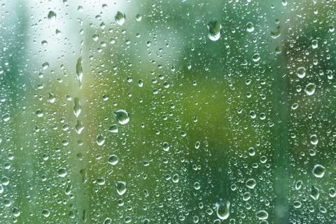 Raindrops on windowpane in summer day. Stock Photos