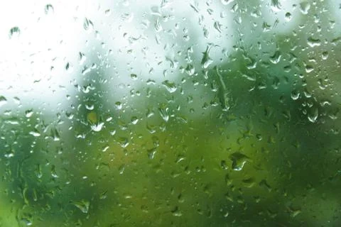 Raindrops on windowpane in summer day. Stock Photos