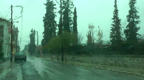 Raindrops on a windscreen during a cloudy afternoon in a small town's street. Vídeos de archivo 35771449