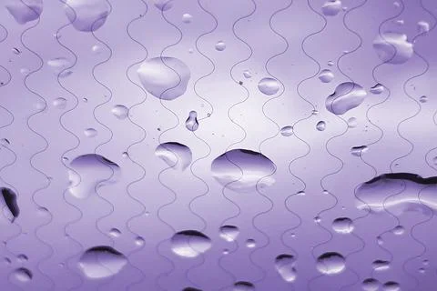 Raindrops on the windshield of the car. Abstract background. Spring rain. Stock Photos