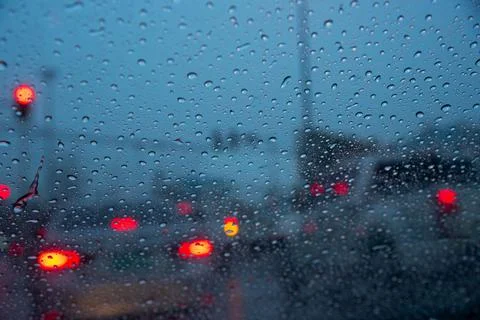 Raindrops on windshield car during traffic jam Stock Photos