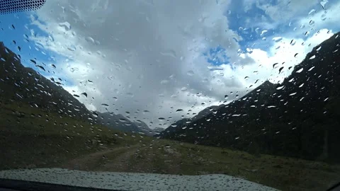 Raindrops on the windshield of a car in nature Video stock 247793500