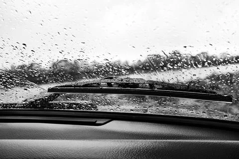 Raindrops on the windshield of a car, view from the inside Stock Photos