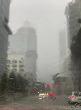 Raindrops on the windshield in the city Stock Photos