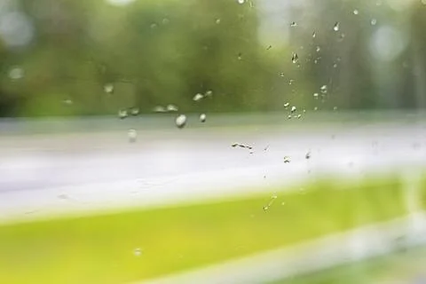 Raindrops on a windshield in cloudy, rainy weather Stock Photos