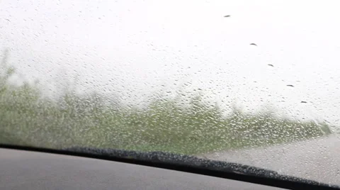 Raindrops on the windshield of a moving vehicle Stock Footage 50129526