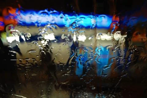 Raindrops on the windshield at night Stock Photos