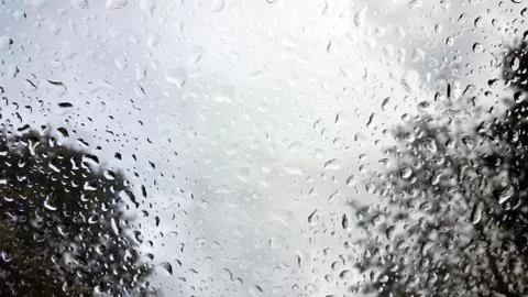 Raindrops on the windshield of a vehicle, captured from within Stock Photos