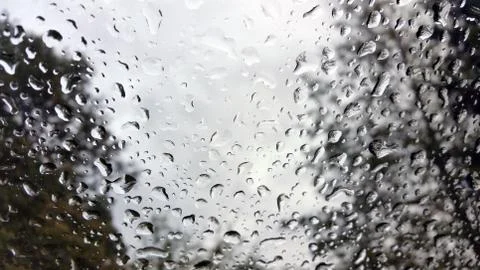 Raindrops on the windshield of a vehicle, captured from within Stock Photos