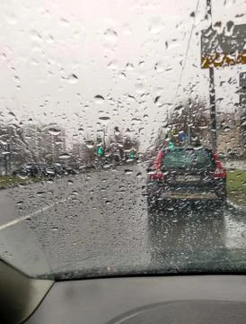 Raindrops on the windshield. View from inside the car Stock Photos