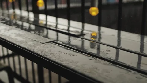 Raindrops on a wooden surface against the backdrop of the city, rain on the Stock Footage 315899476