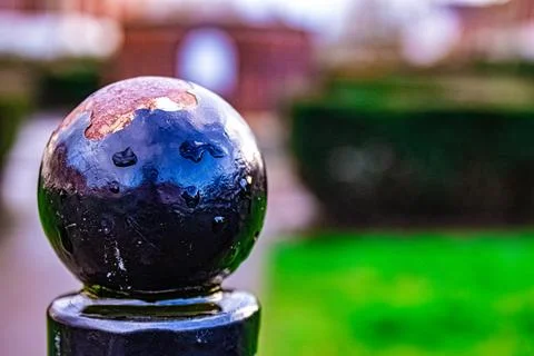 Raindrops on a Worn Black Sphere Stock Photos