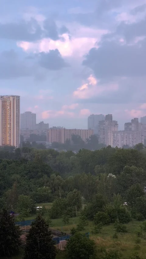 Rainfall against the backdrop of a city landscape on a summer day. Vertical.. Stock Footage 285398844