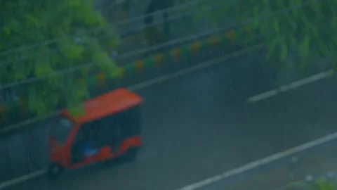 Rainfall and traffic moving on road Stock Footage 314887696