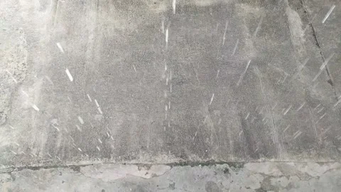 Rainfall on Concrete Pavement – Raindrops Hitting Ground in Motion Stock Footage 308817309