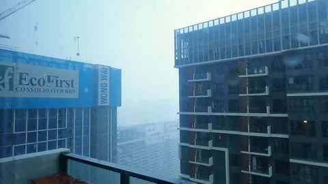 The rainfall outside my balcony window in Kuala Lumpur. A huge crane is Stock Footage 341078841