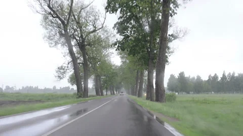 Rainfall water on car automobile windscreen  driving on road Stock Footage 37776208