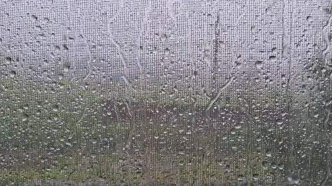 Rainfall on a Window Screen with Water Droplets Stock Footage 342030670