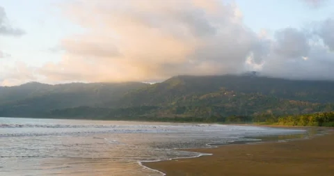 Rainforest Coastline Sunset With Colorful Clouds And Vacant Natural Beach Waves Stock Footage 138070940