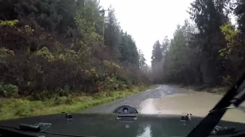 Raining and driving through mud puddle Stock Footage 172564864