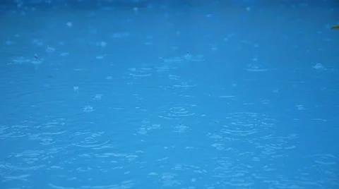 Raining on Blue Swimming Pool Water. Stock-Footage 44169830