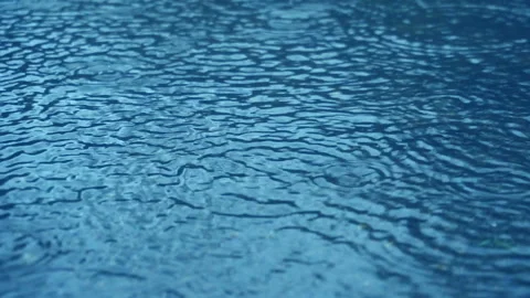  raining on blue water surface Stock Footage 161324629