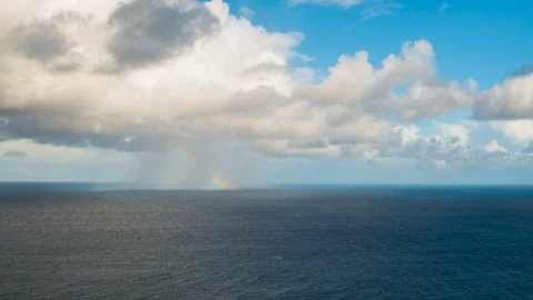 Raining Cloud and Rainbow over the Ocean Stock Footage 103694120