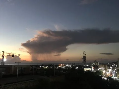 Raining clouds in sunset Stock Photos