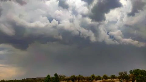 Raining cloudscape, dramatic view of dark raining clouds Stockfoto's