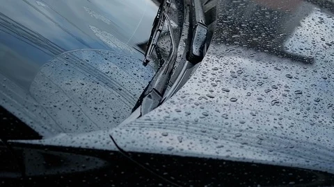 Raining day. Rain drop on windshield of black car parked on road. Video stock 92299458