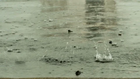 Raining droplets drop falling on ground of wet cements. Stock Footage 116593177